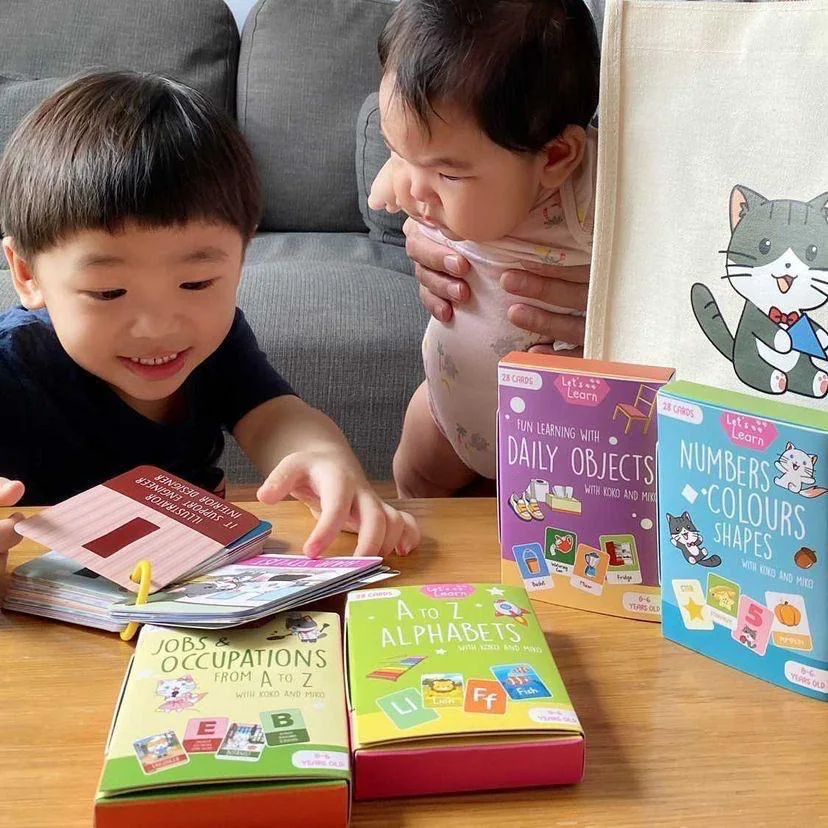 Children exploring colourful Koko and Miko flashcards